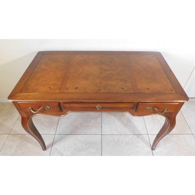 Elegant vintage Louis XV mahogany gold trim writing desk. Solid mahogany wood writing desk features three dovetailed...