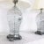 Fabulous pair of 1960s Hollywood Regency style cut crystal table lamps. Metal bases with nickel coating. Shades included.