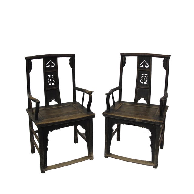 This pair antique Chinese high yoke back armchairs has a back splat adorn with nicely carved Buddhism symbol for peace and...