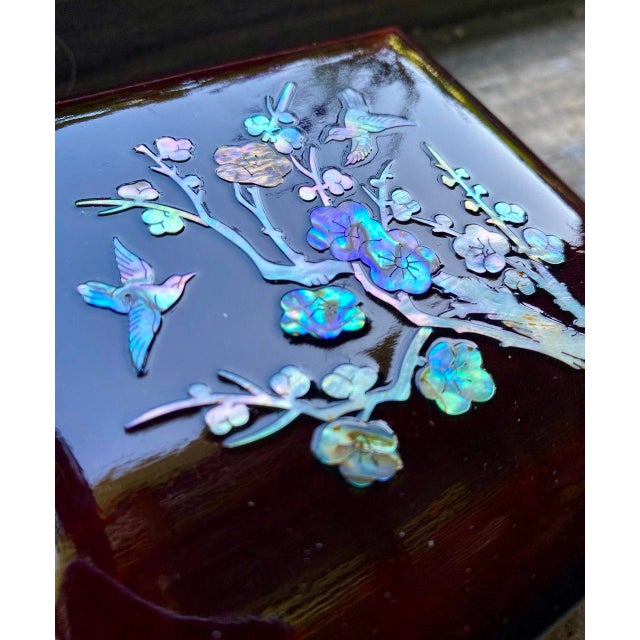 A beautifully understated mid-century Korean lacquer jewelry box featuring luminous mother-of-pearl inlay depicting...