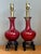 This exquisite pair of table lamps features the iconic Sang de Boeuf, or "oxblood," glaze—a classic ceramic technique...