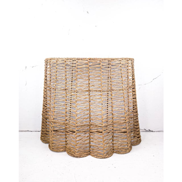 A vintage woven seagrass demi-lune table that's a sweetly chic addition to any room. We see it providing a display surface...