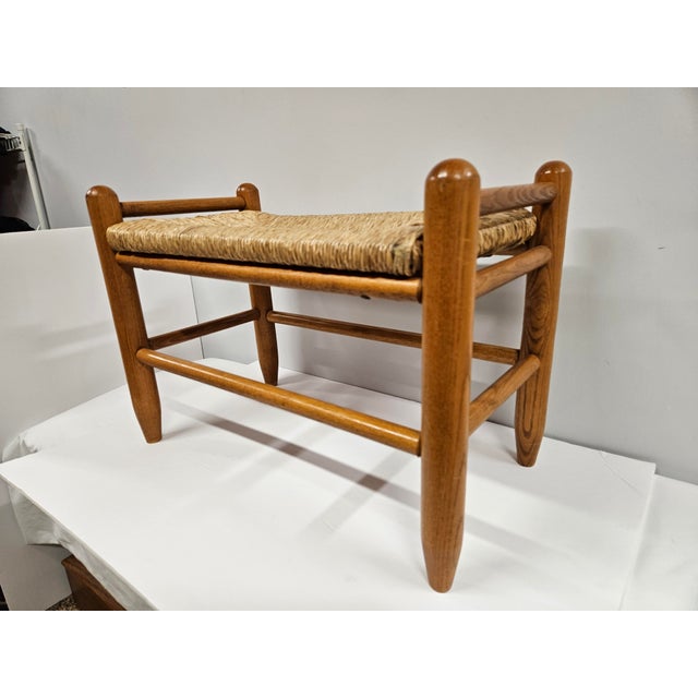 This Danish Modern style rush seat footstool or low bench is ready for use. The stool is in good vintage condition. There...