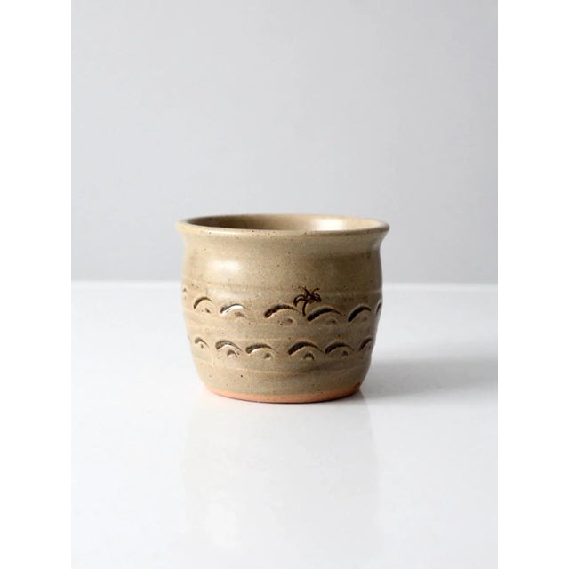 This is a vintage studio pottery cachepot. Signed by the artist, the hand-crafted vase features a speckled tan glaze with...