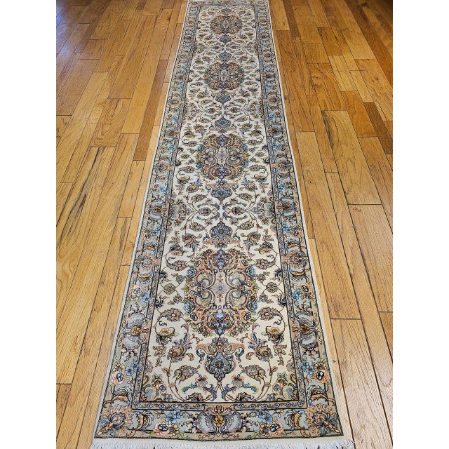 "This exquisite Persian Tabriz runner, woven in the late 1900s, showcases a sophisticated medallion floral pattern...