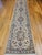 "This exquisite Persian Tabriz runner, woven in the late 1900s, showcases a sophisticated medallion floral pattern...