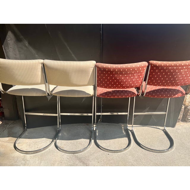 A glamorous, design-ready set of four vintage 1970s modernist bar-height stools, manufactured by the prominent California...