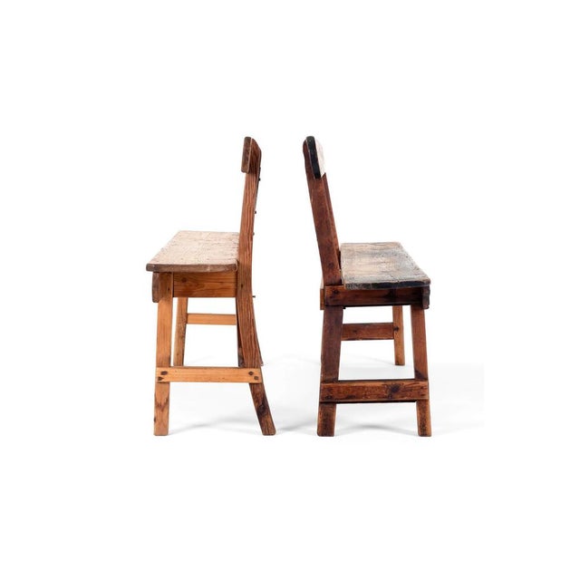 A splendid pair of rustic pine benches reclaimed from an old mill. Each bench has a high back and the bases are united...