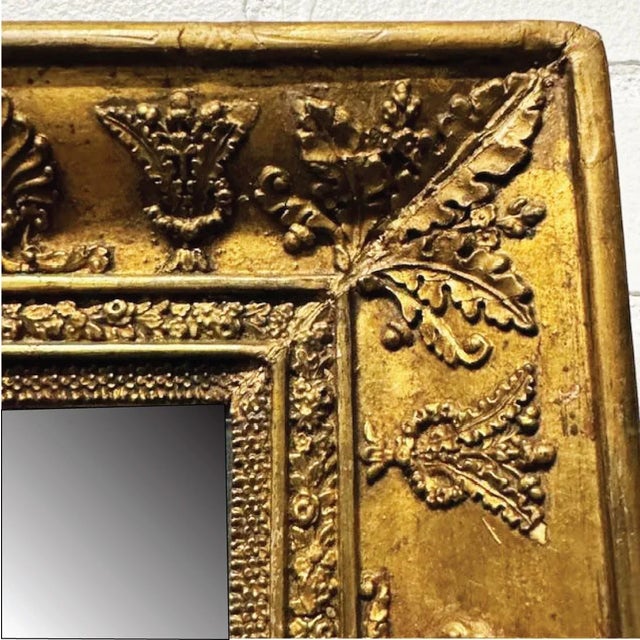 A very detailed 19th century French Giltwood Mirror in the First Empire style. This less typical example has an abundance...