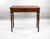 An Edwardian mahogany writing table in the Georgian revival taste, having a rectangular top above a pair of opposing...