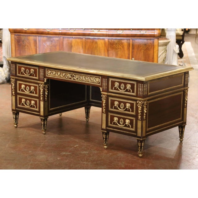 Commanding in scale and exceptionally detailed, this antique executive desk would make a striking centerpiece for a...