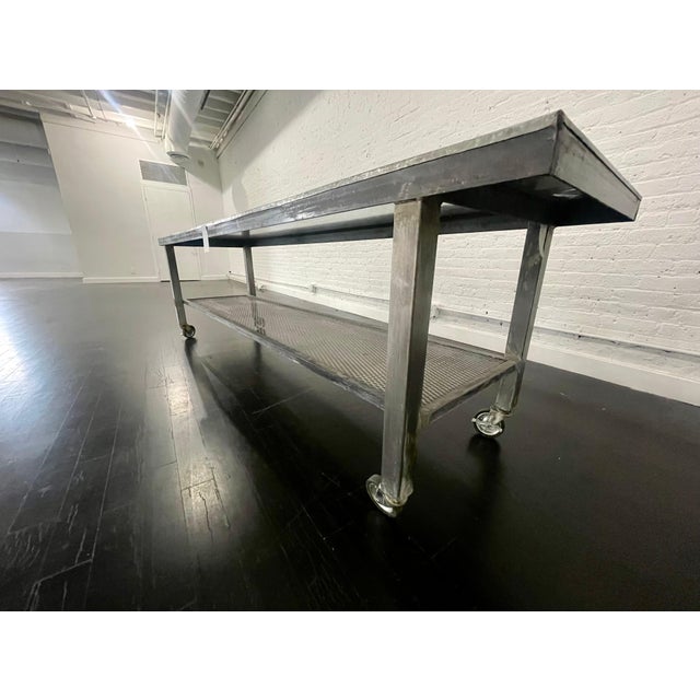 Vintage style metal Industrial table on wheels, circa 2000 Industrial table made of steel on wheels.
