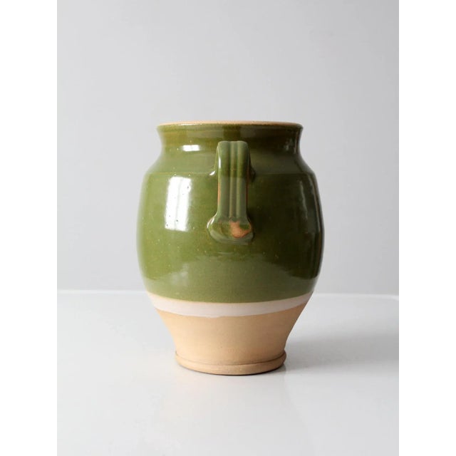 A vintage Rowe Pottery Works vase by potter John Tiller, in a classic amphora-inspired form. The body features a grass...
