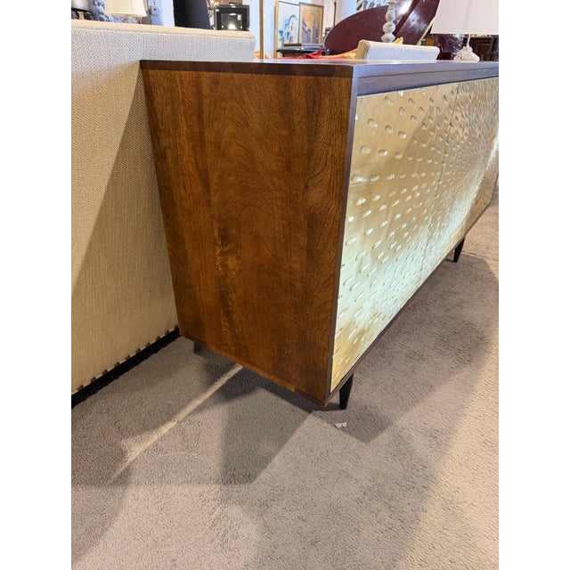 Make a bold statement with this striking Coast to Coast three-door sideboard, where modern design meets artistic texture....