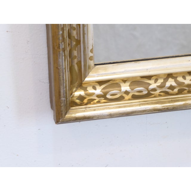 This small silver-gold mirror has a stenciled design in the cove and measures 20.25"H x 17.5"W.