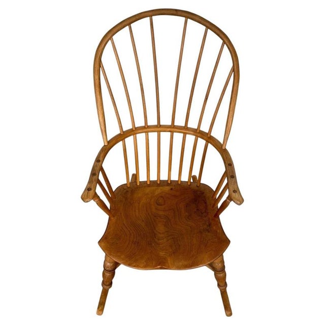 A charming early 20th-century English rocking chair, finely crafted from ash and distinguished by its traditional spindle...