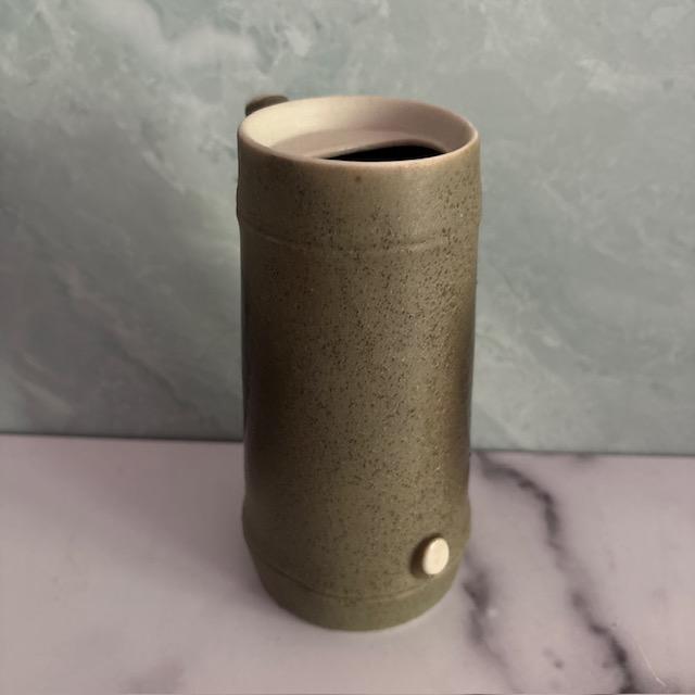 Nice mid-century Sake set, comprised of pitcher and 2 cups. Made of green and cream-colored pebbled ceramic. Original...