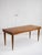 Solid wood dining table with scalloped apron. Bookmatched wood veneer makes a geometric pattern on table top. Sourced in...