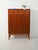 1950s mahogany cabinet with four upper drawers, hinged doors, and slender legs with a distinctive design. Scandinavian...