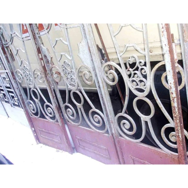 Antique Art Deco period wrought iron doors with transom having stylized linear and scrolled design. Depth of the frame is...