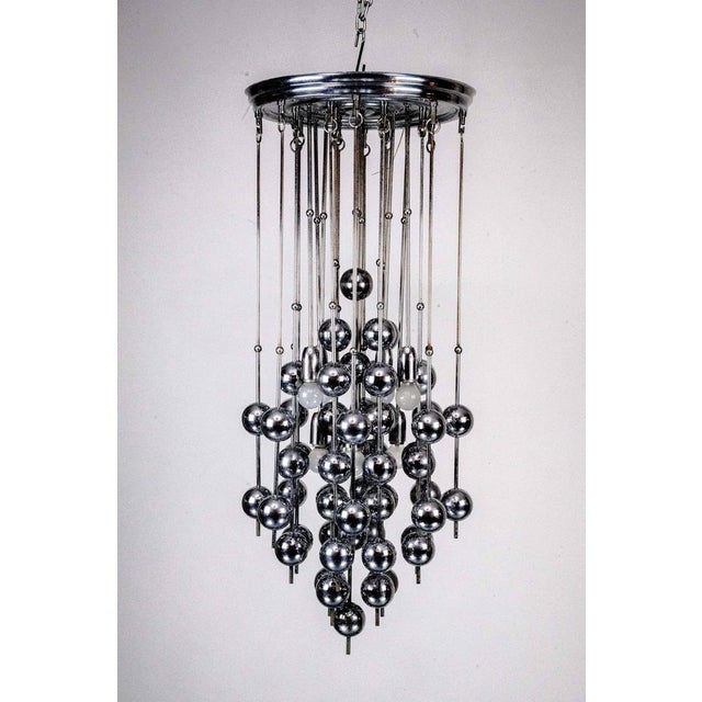 Striking Italian chandelier from the 1970s, featuring a cascade design composed of multiple chrome-plated metal rods...