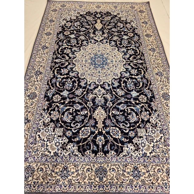 "This exceptionally fine handwoven Persian Nain rug, signed by the renowned Habibian workshop, was crafted in the 4th...