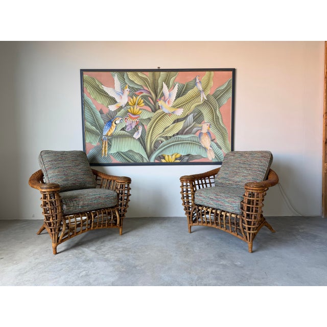 Beautiful vintage organic rattan lounge chairs featuring an eye-catching open lattice design with sculptural curved frames...