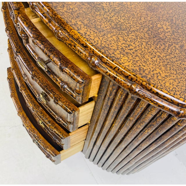 This is a handsome Regency Inspired faux tortoiseshell chest of drawers. this chest of drawers has faux bamboo Detailing...