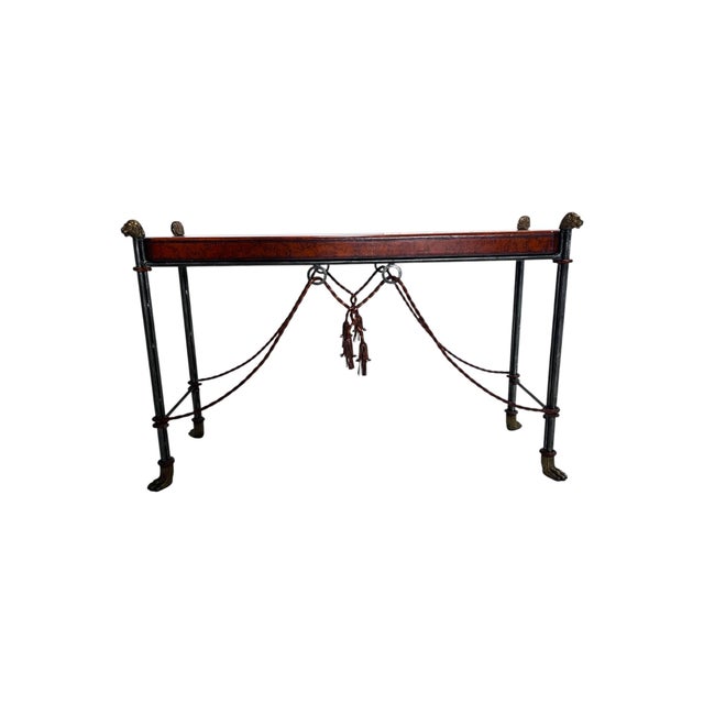 A Maitland Smith Leather Top Lion Head Console, 1990s. This handsome steel and brass console table is beautifully accented...