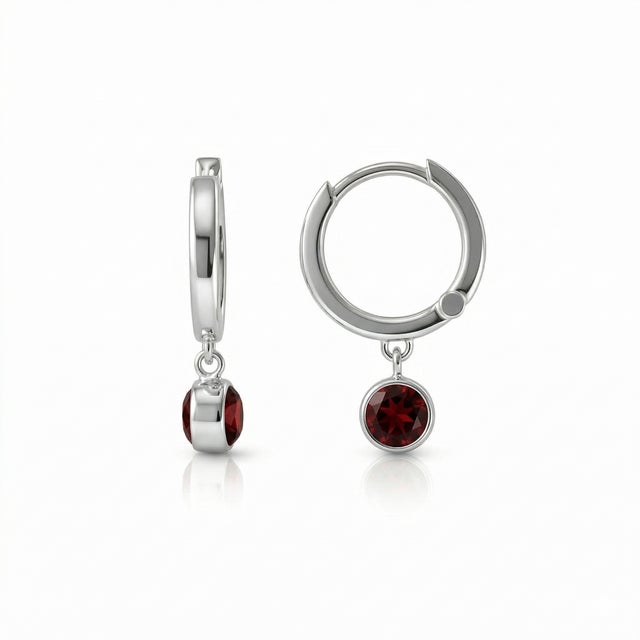 These elegant hoop earrings feature captivating Garnet gemstones, known for their rich deep red hue and timeless appeal....