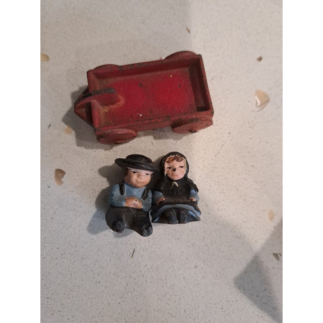 Lot of toys from the early 1900's Iron fire wagon and horses Iron wagon with Amish children Small metal fire wagon and...