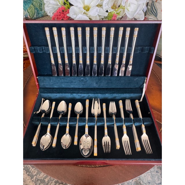 An elegant vintage 64-piece flatware set in the Golden Corsica pattern by Wallace, crafted in quality 18/10 stainless...