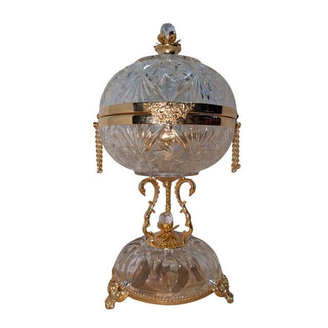Vintage cut glass perfume tantalus, or fragrance caddy, in the antique tantalus style: a hinged cut-glass lid on a footed...