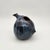 Sculptural stoneware creamer with organic bird-like form, mottled deep blue-black glaze, pinched spout, and small tail detail