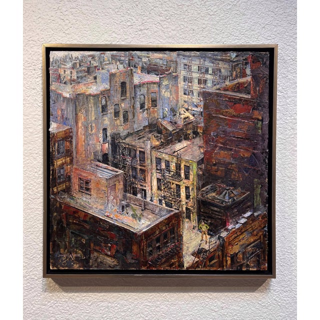 This mixed media work on wood panel presents a vibrant urban landscape, capturing the intricate details of rooftops and...