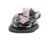 A carved sculpture features a composition of three pig figurines, rendered in vibrant pink rhodonite stone, resting on a...