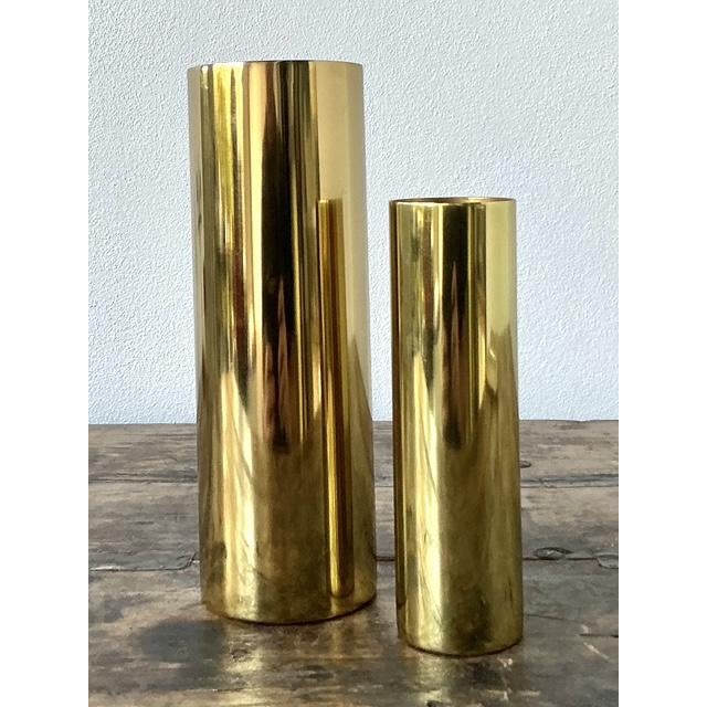 These elegant vintage brass cylinder vases are a masterful exercise in minimalist design. Crafted from heavy-gauge solid...