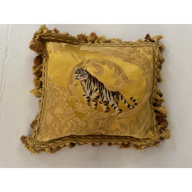 A handsome Fortuny silk pillow with an embroidered tiger in the center. Tassel fringe in alternating yellow and gold....