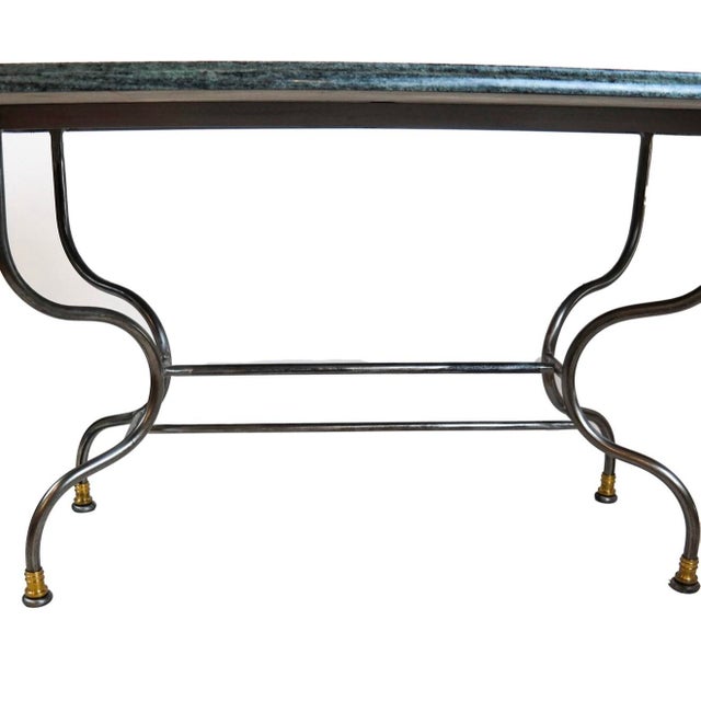 An elegant and generously proportioned contemporary dining table featuring a substantial rectangular marble top supported...