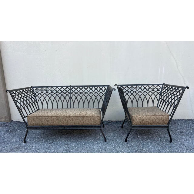 Charming wrought iron patio/outdoor settee and chair black Metal patio bench and chair where every curve and line whispers...