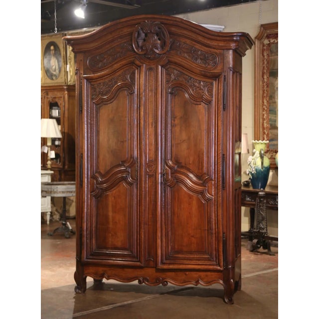 This important antique French armoire Lyonnaise, crafted in Lyon circa 1760, is a striking example of Louis XV provincial...