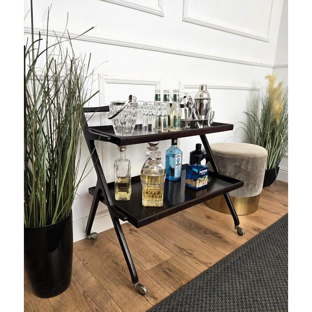 Unique and very elegant Italian Mid-Century Modern Art Deco dry bar cabinet cart with two tiers and highlighted by the...