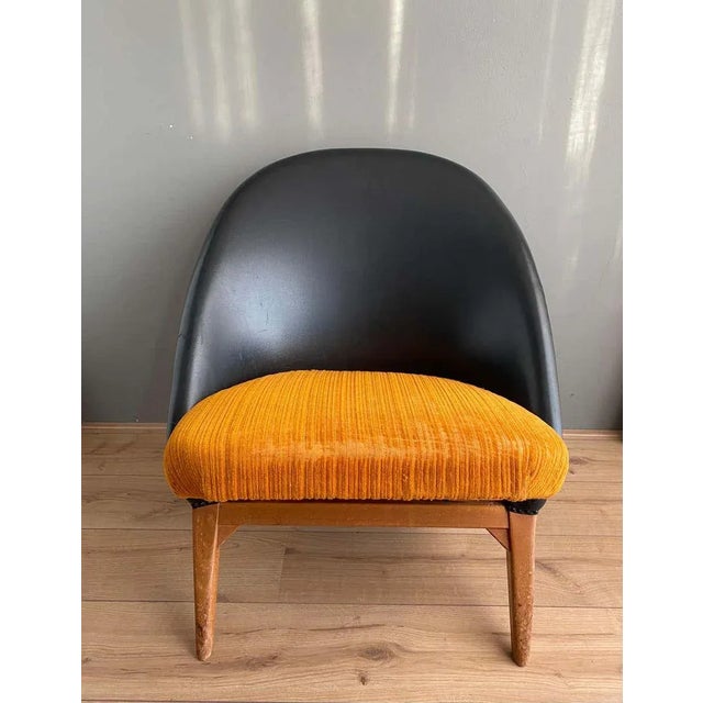 Early piece designed by Theo Ruth for Artifort. Features a Black Leatherette Backrest and Orange fabric upholstery upon...