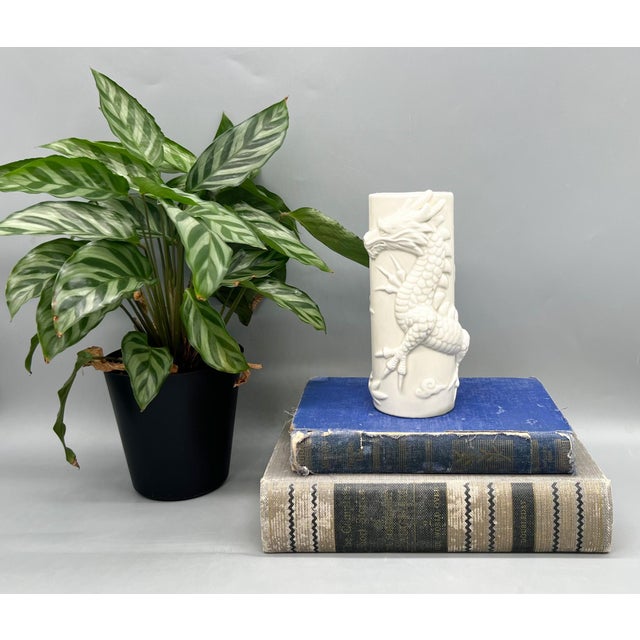 Striking 1977 Fitz & Floyd blanc de chine ceramic vase featuring a beautifully sculpted high-relief dragon wrapping around...