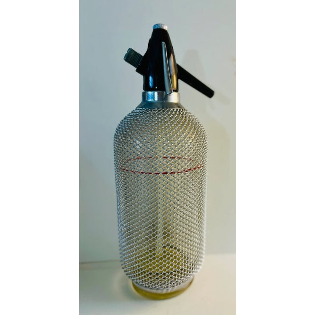 Vintage 1960s ACC syphon seltzer bottle, Czechoslovakia. Heavy glass sheathed in metal mesh. I have no idea whether it...