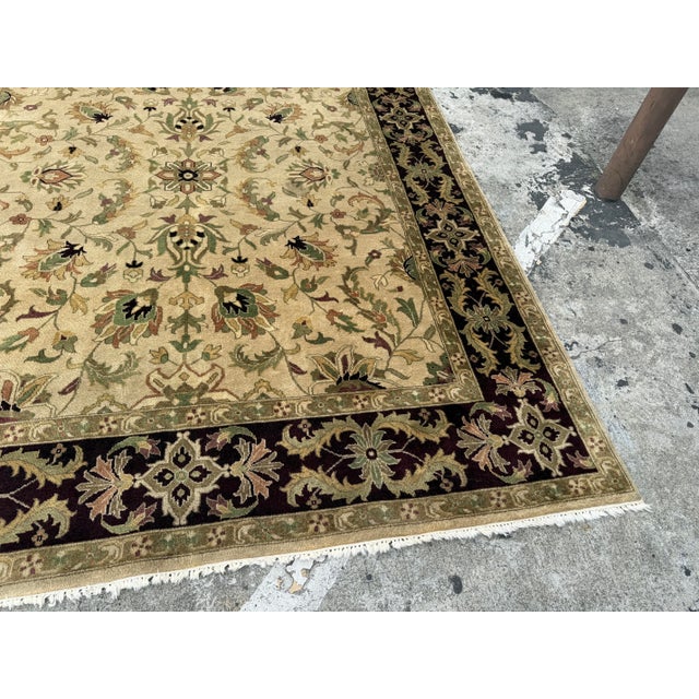 Design Plus Gallery presents a 7ft 10in x 9ft 11in Area Rug. The rug has a thick, deep plum border with brightly toned...