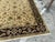 Design Plus Gallery presents a 7ft 10in x 9ft 11in Area Rug. The rug has a thick, deep plum border with brightly toned...