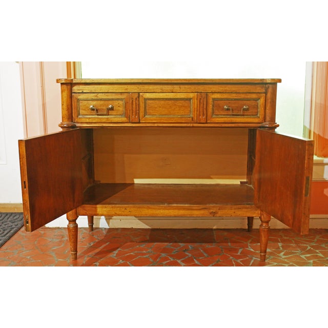 Circa 1930s French Directoire style small buffet. Walnut. Single drawers with 3 faux drawer facings over cabinet doors....