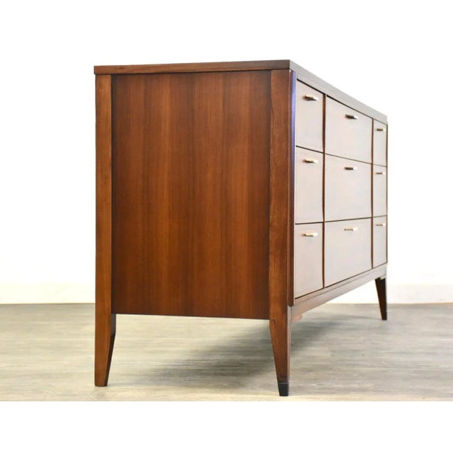 A mid century modern walnut nine drawer dresser made by Kent Coffey Tempo. Professionally refinished. 64” wide. 19” deep....