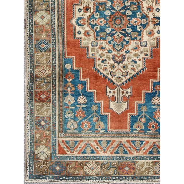 Vintage Turkish Oushak Rug in Blue, Terracotta, Light Brown and Camel. Renowned for their distinctive composition and use...